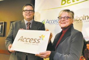 boris minkevich / winnipeg free press files Access Credit Union board chairman Darryl Loewen and Margaret Day of Assiniboine Credit Union were all smiles in February, when the merger was first announced. The membersÕ vote in April, however, quashed the plan.